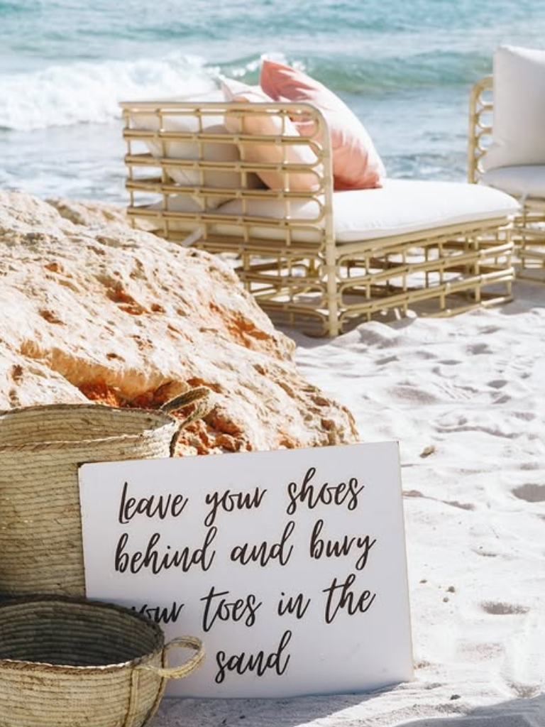 Midday cocktail hour beach setup for a wedding